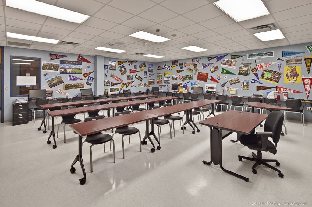 Bright classroom featuring colorful world map wall mural and student workstations