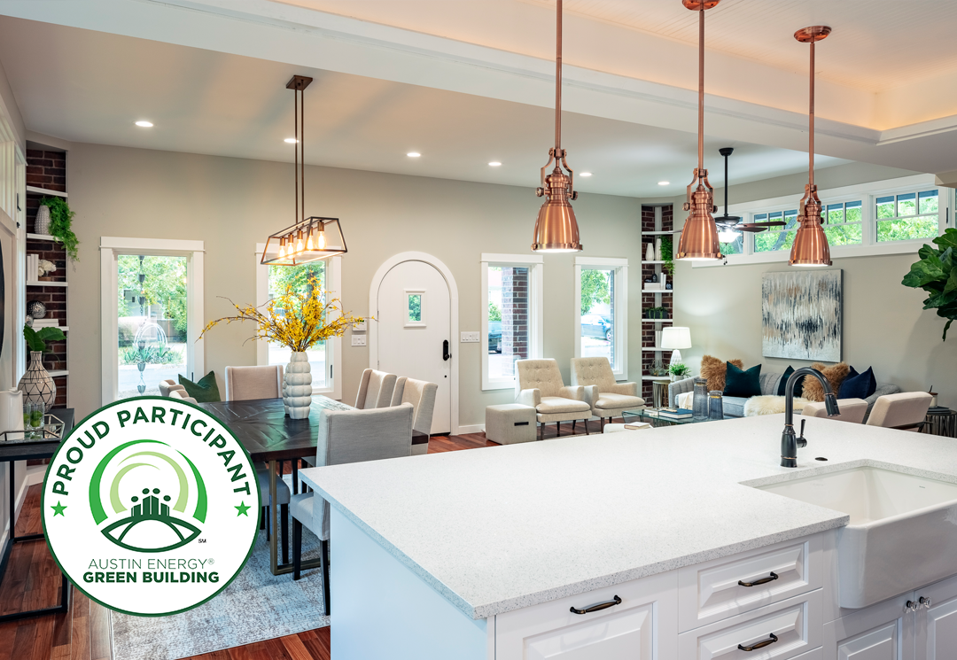 Open kitchen and dining area with copper pendant lights and Austin Energy Green Building badge
