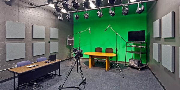 Student broadcast studio with green screen, stage lighting, and camera equipment, Reagan High School renovation, Austin TX