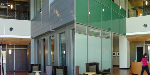 Multi-story atrium lobby with green glass curtain wall, frosted glass partitions, and modern lounge seating, Nokia Creation Center II